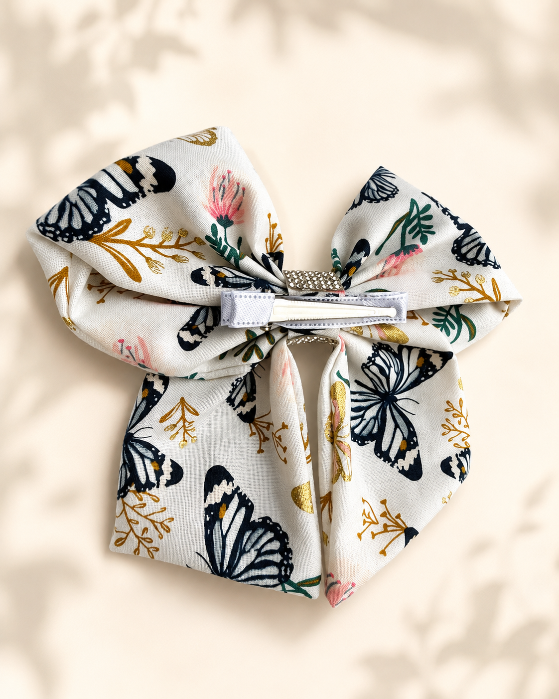 Styled flat lay of Flutter & Bloom Bow, 6-inch boutique hair bow