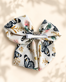 Styled flat lay of Flutter & Bloom Bow, 6-inch boutique hair bow
