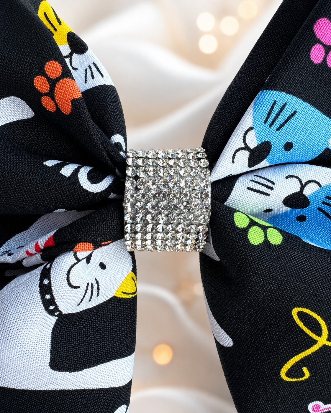 6 inch black cat hair bow with colorful yarn and paw print pattern