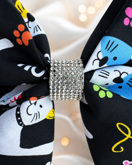 6 inch black cat hair bow with colorful yarn and paw print pattern