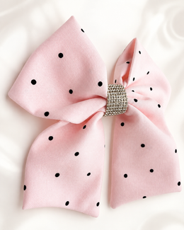 Close-up of Blushing Dottie Bow, 6-inch blush pink polka-dot hair bow showing fabric and center detail