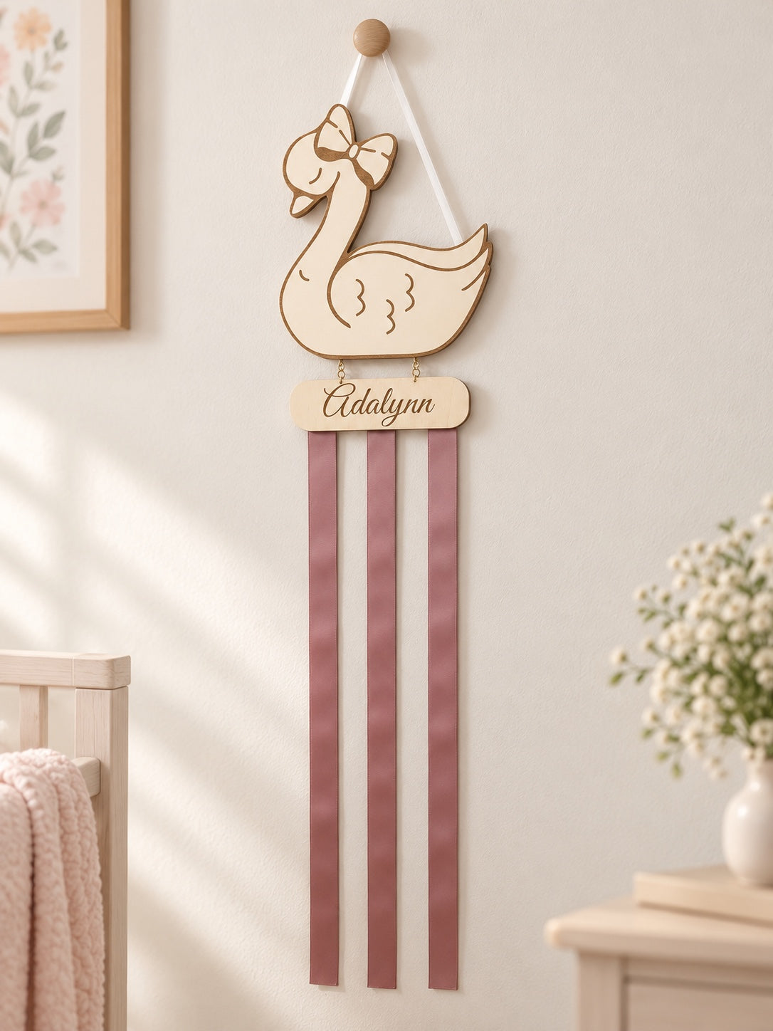 Full-length personalized swan bow holder with three mauve ribbons