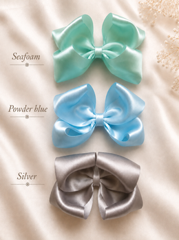 Angled product view of The Classic Everly Bow, approximately 5.5-inch satin hair bow
