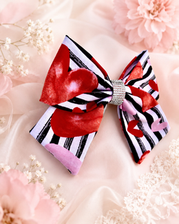 Styled flat lay of Love in Paris, approximately 6-inch striped heart hair bow