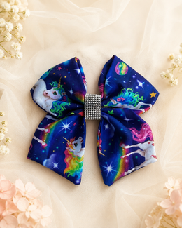Unicorn space print boutique bow for girls in navy blue and rainbow colors