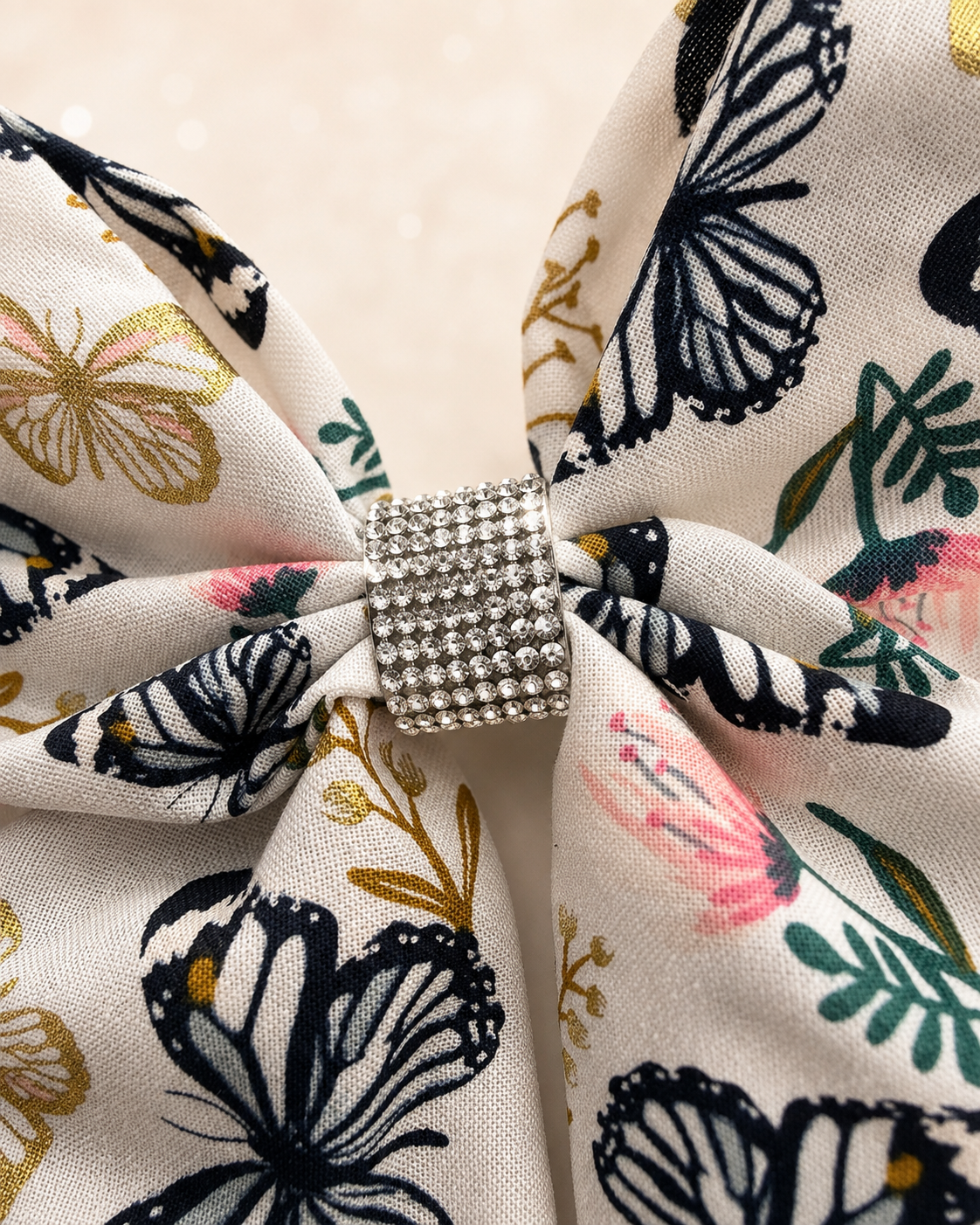 Close-up of Flutter & Bloom Bow, 6-inch boutique hair bow showing fabric and center detail