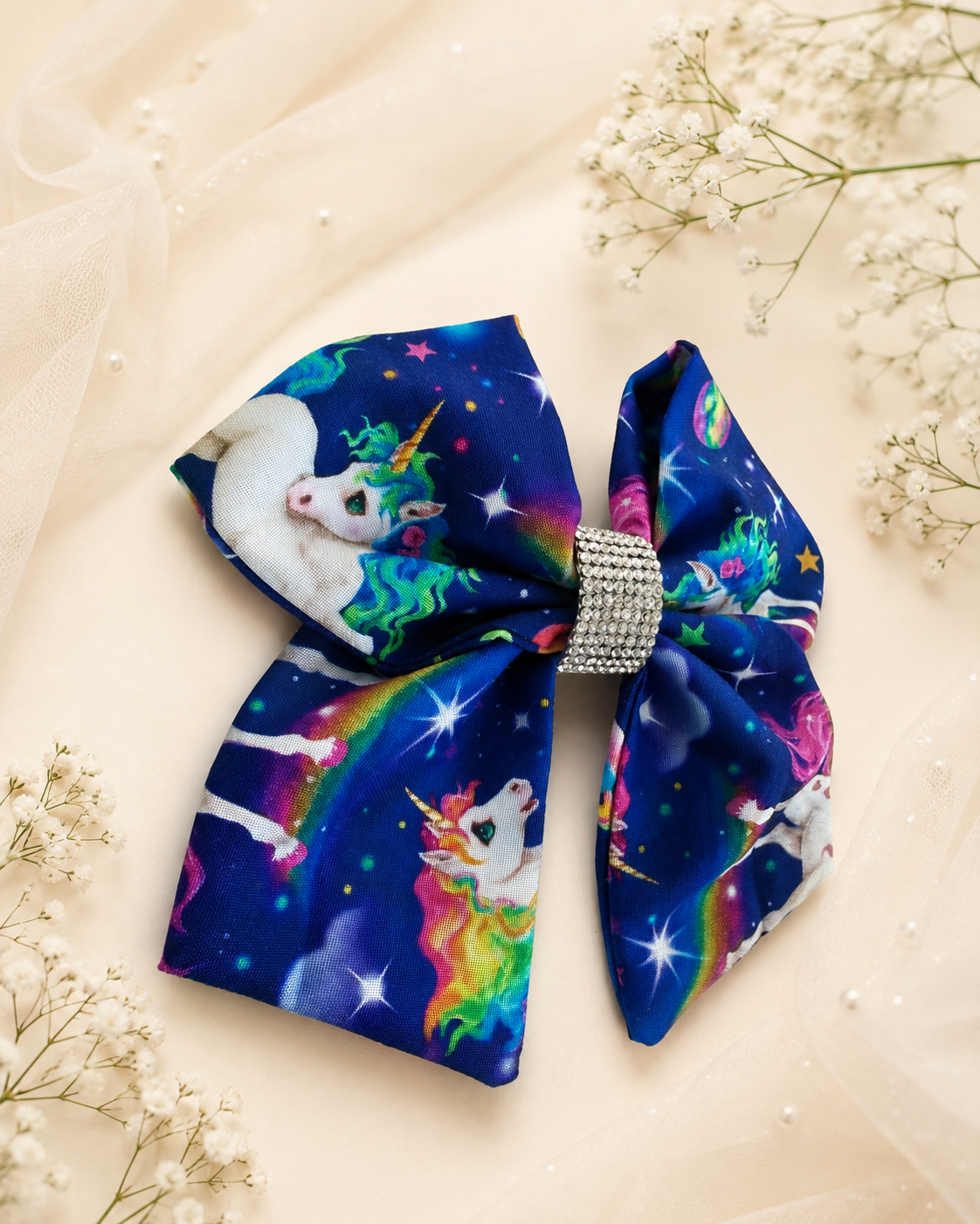 6 inch navy unicorn hair bow shown for size with colorful space print