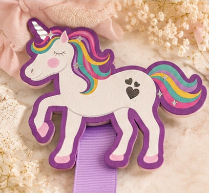 Rainbow unicorn bow holder shown with decorative hair bows