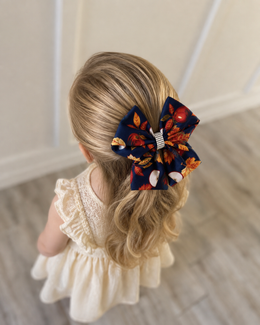 Apple Orchard, 6-inch fall hair bow worn in a girl's hairstyle to show scale