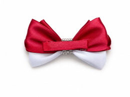 A double-layered bow accessory featuring a top red satin layer and a bottom white satin layer, accented with a small silver rhinestone band in the center, shown on a plain white background.