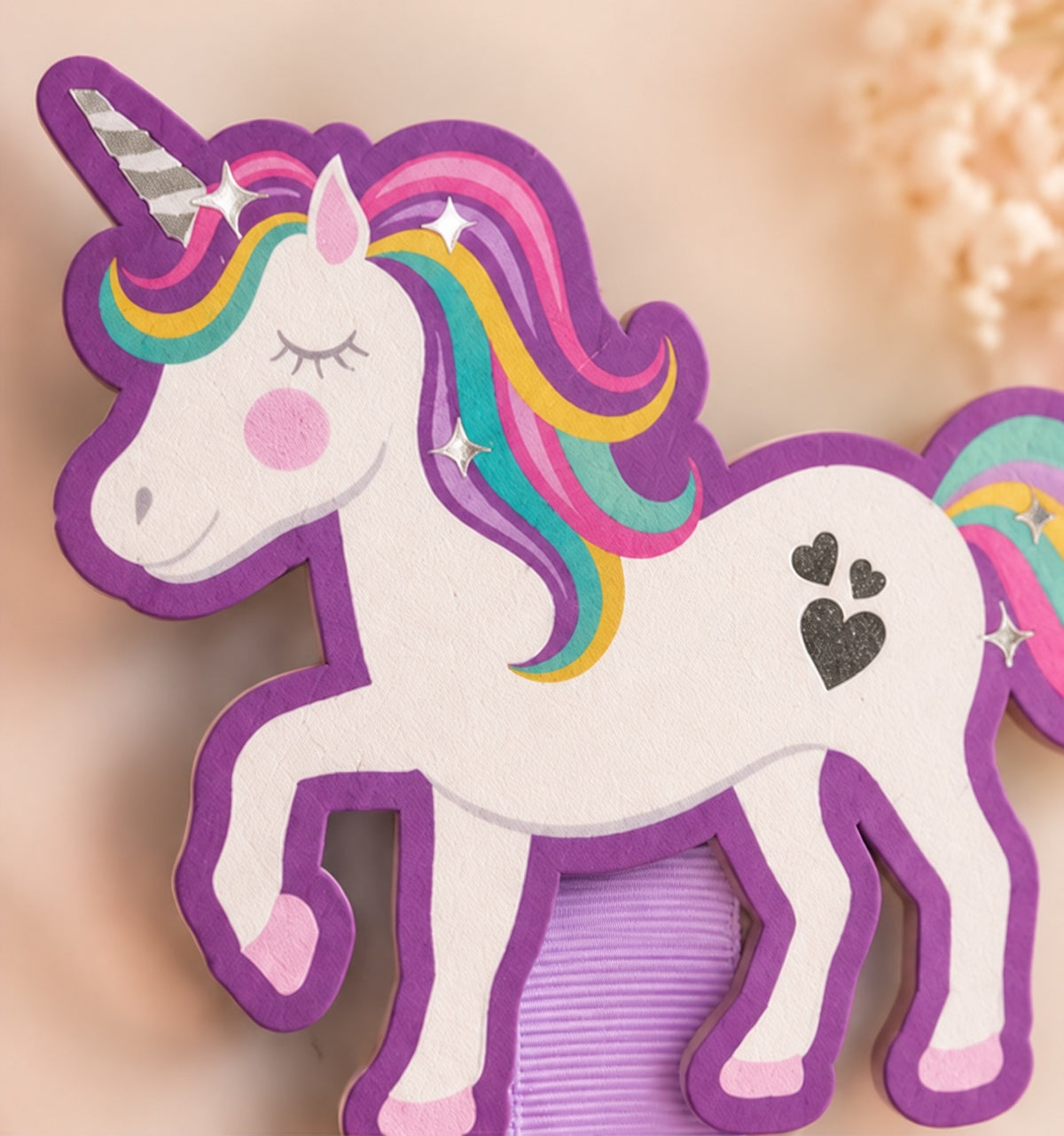 Close-up of the 4 by 4 inch wooden rainbow unicorn topper