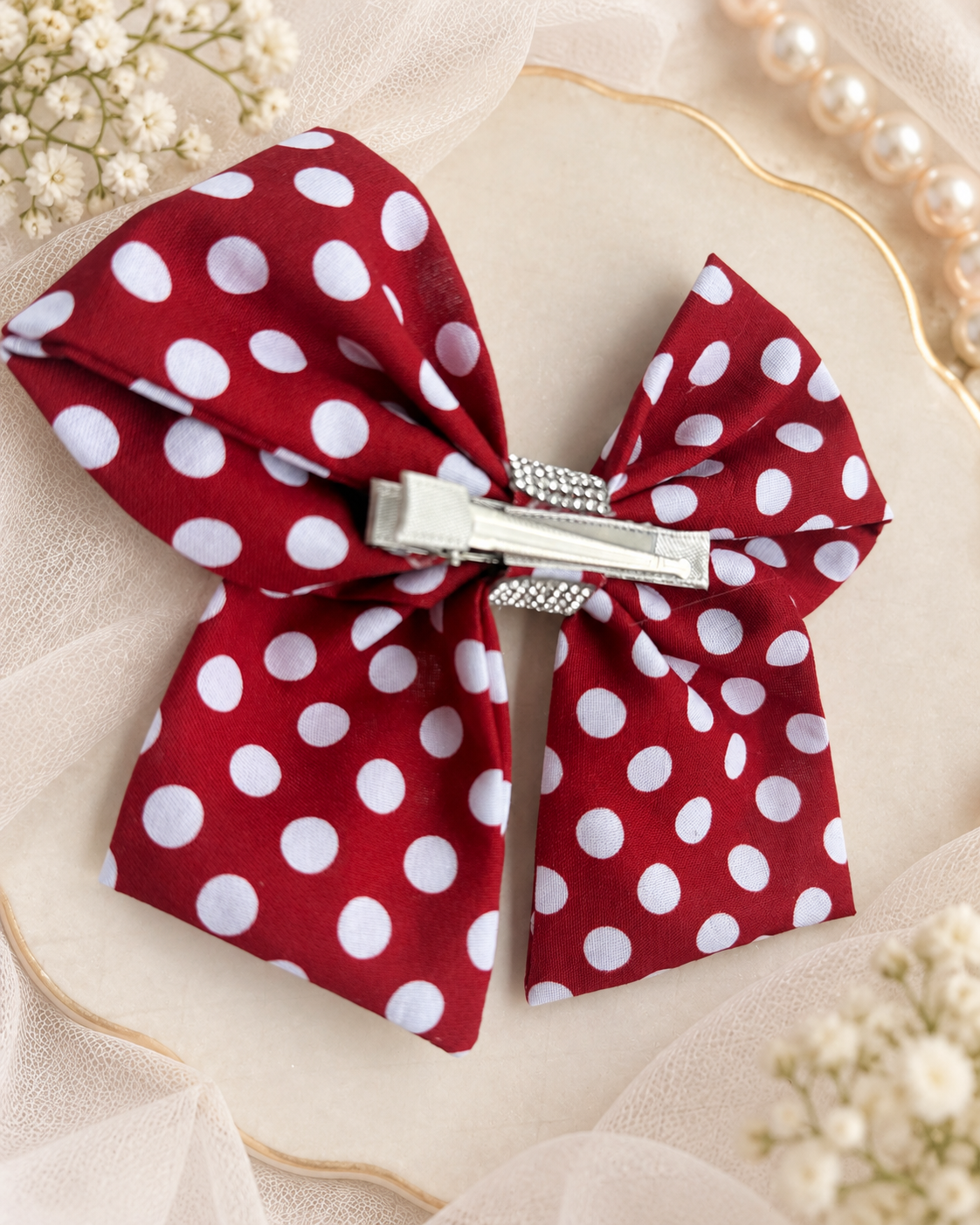 Classic red polka dot boutique hair accessory with sparkling rhinestone center