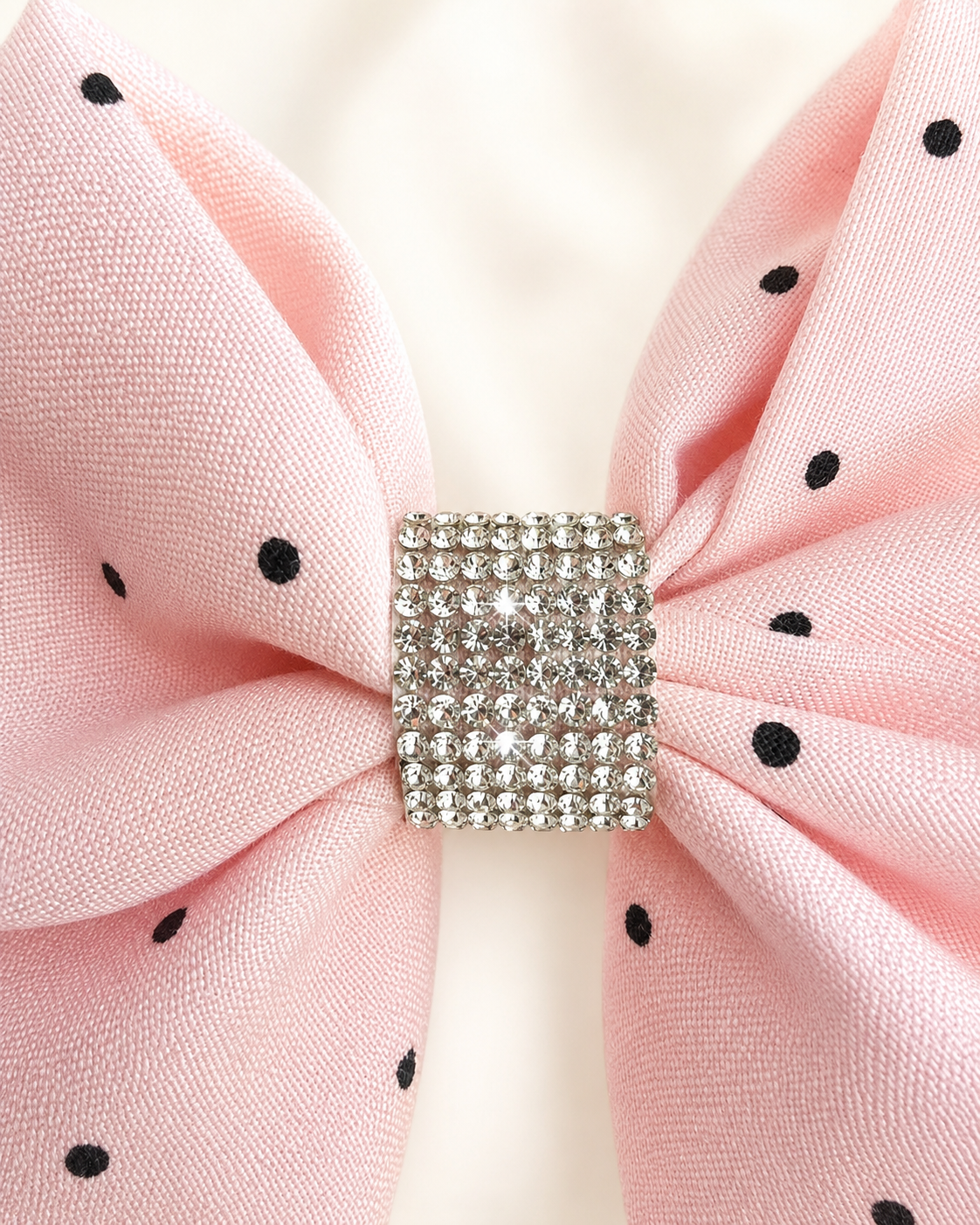 Angled product view of Blushing Dottie Bow, 6-inch blush pink polka-dot hair bow