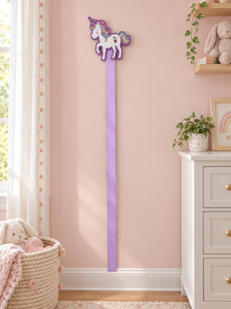 Rainbow unicorn bow holder displayed in a soft pink nursery
