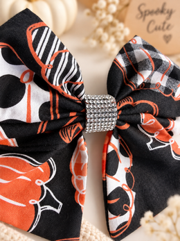 Pumpkin print boutique hair bow with checks stripes polka dots and rhinestone center