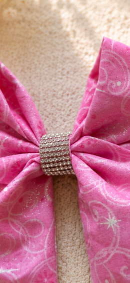 Close-up of Once Upon a Sparkle, 6-inch pink fabric hair bow showing fabric and center detail