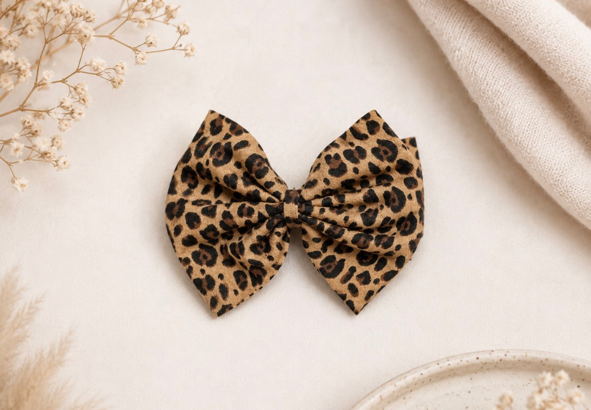 Front product view of Little in Leopard, leopard bow headband