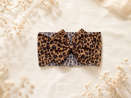 Angled product view of Little in Leopard, leopard bow headband