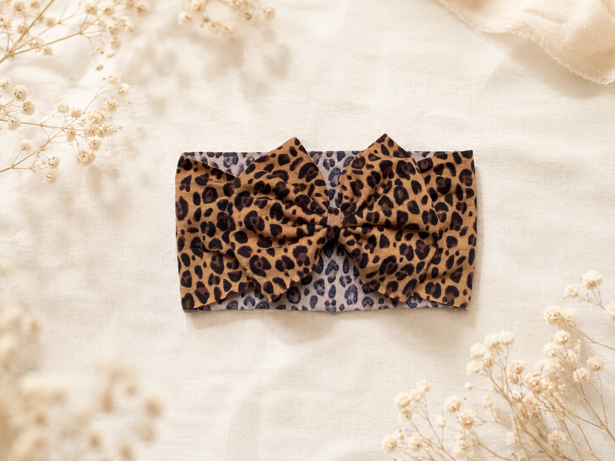 Angled product view of Little in Leopard, leopard bow headband