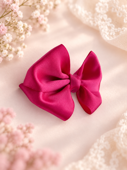 Close-up of Berry Kiss fuchsia satin mini hair bow