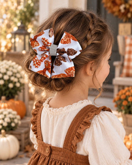 Little girl wearing Autumn Ribbons 5.5 inch fall hair bow in a braided updo with an autumn outfit