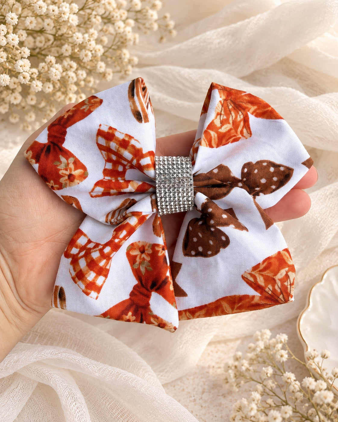 Autumn Ribbons 5.5 inch fall hair bow shown in hand for size reference