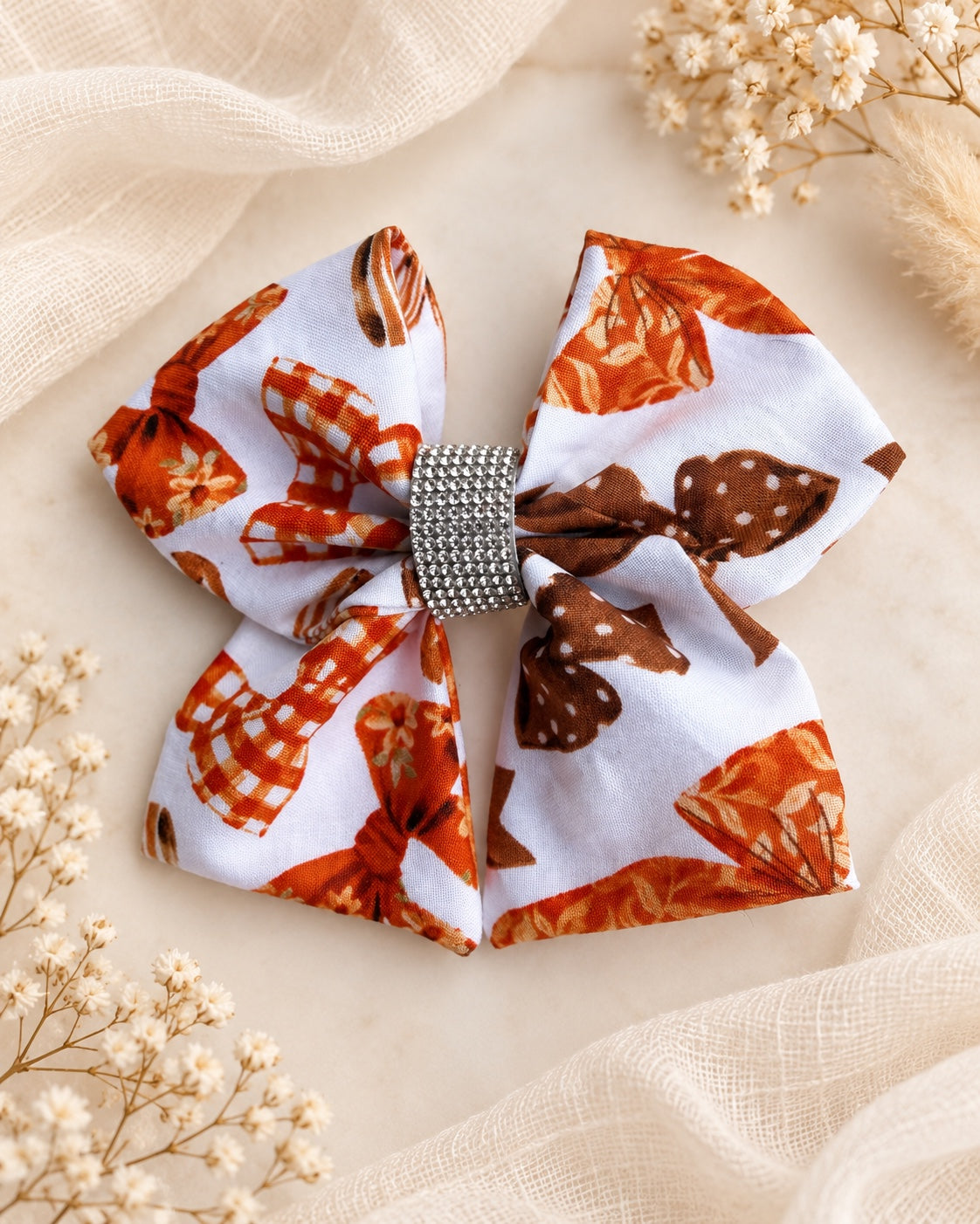 Autumn Ribbons 5.5 inch girls fall hair bow styled on a soft ivory background
