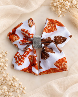 Autumn Ribbons 5.5 inch girls fall hair bow styled on a soft ivory background