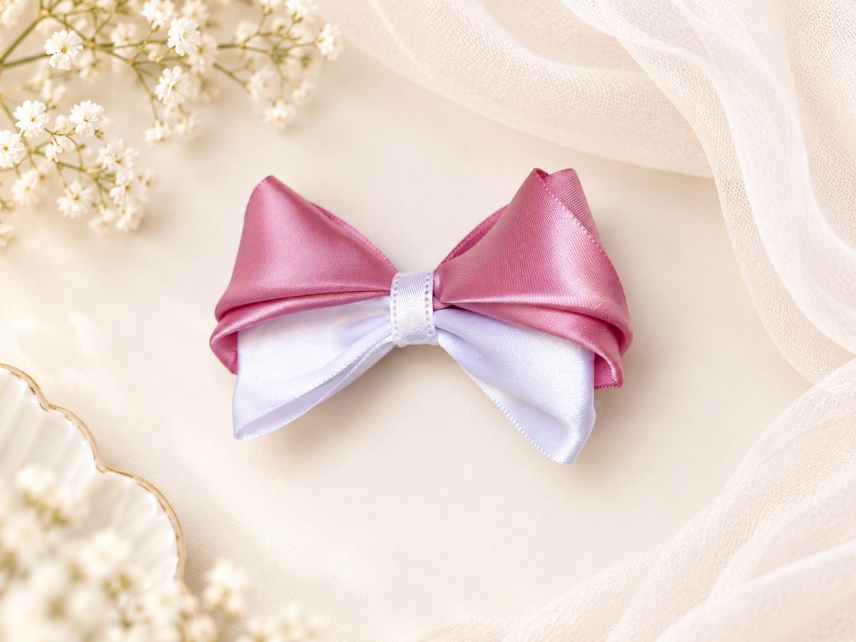 Pink and white 3.5 inch satin boutique hair bow styled on a soft ivory background