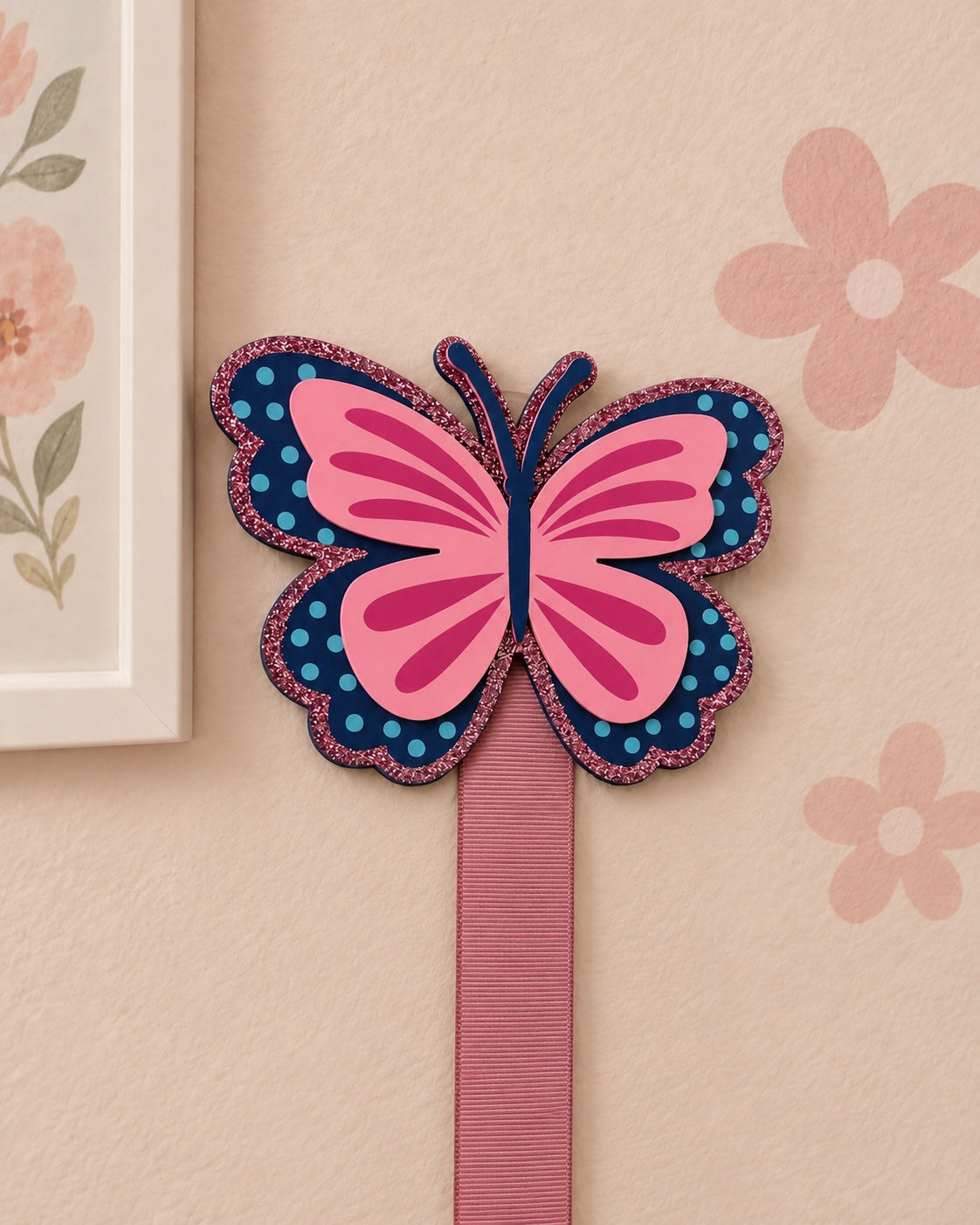 Close-up of butterfly bow holder with one pink ribbon