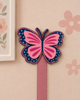 Close-up of butterfly bow holder with one pink ribbon