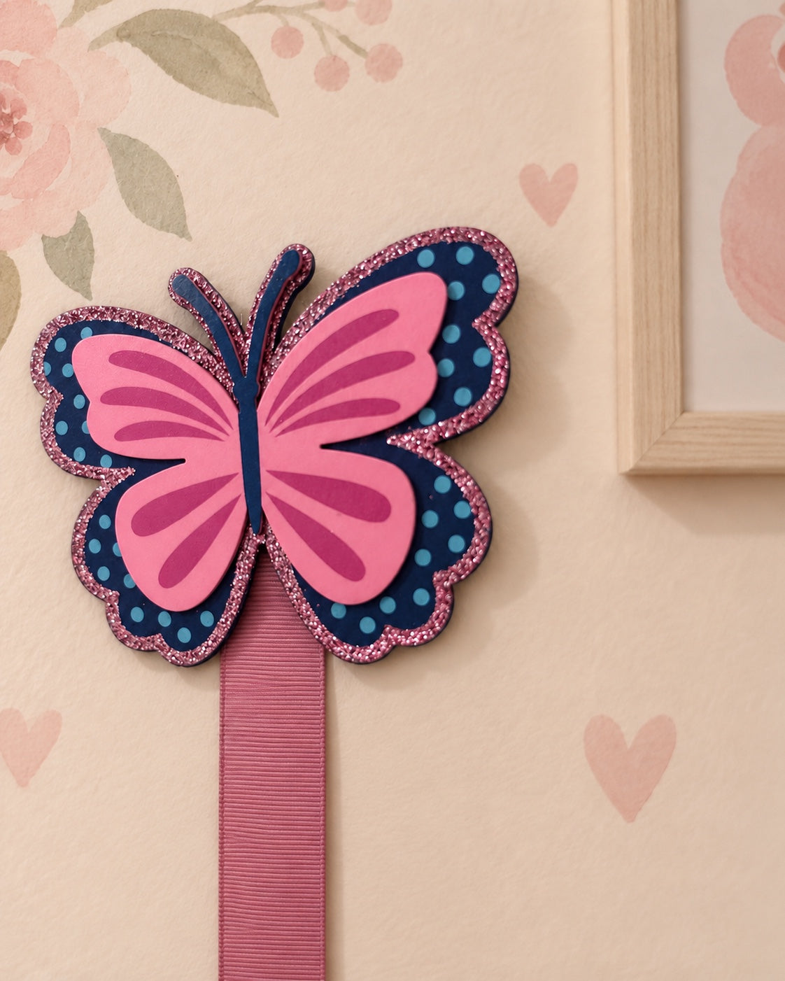 Detailed close-up of pink and navy butterfly bow holder