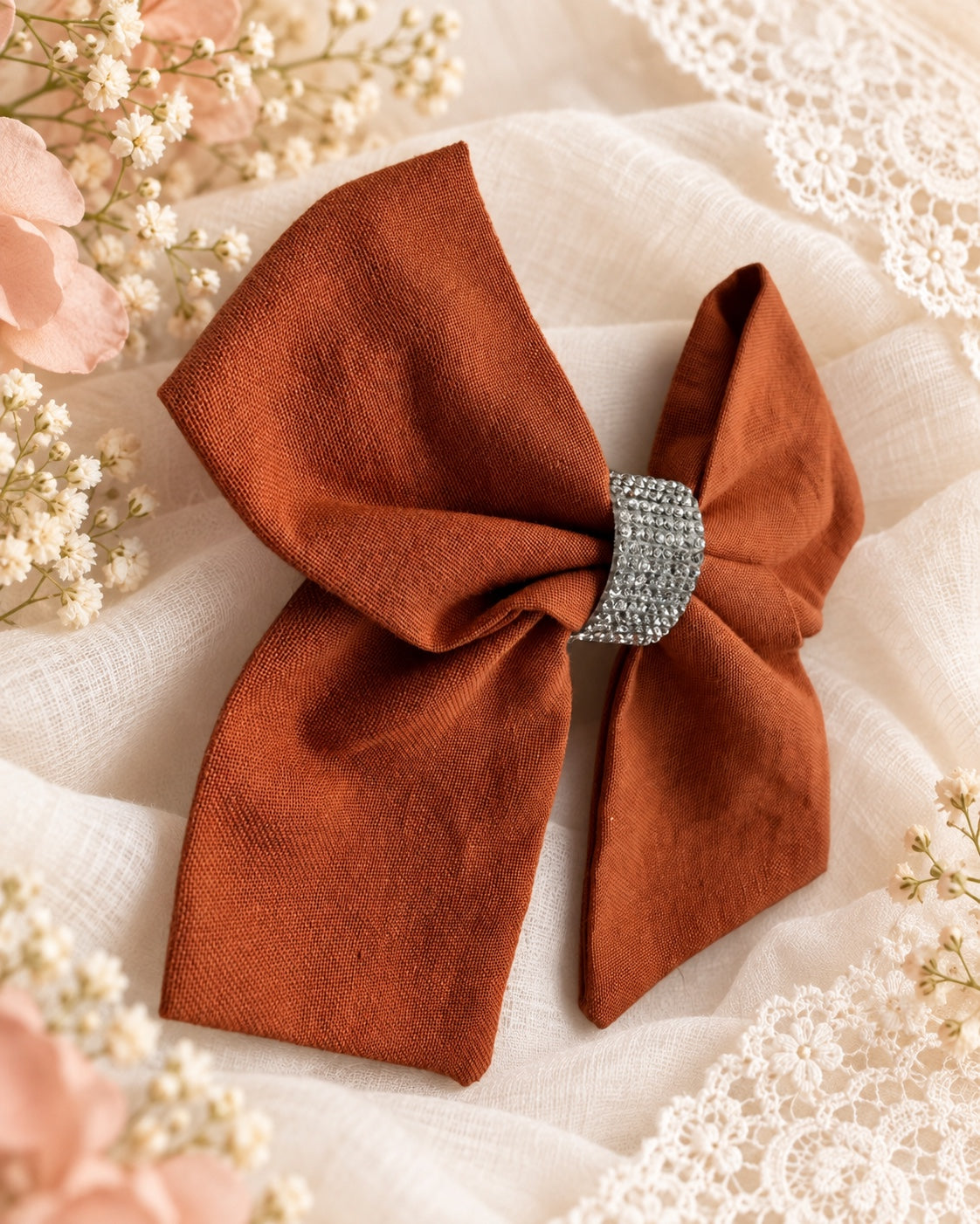 Burnt orange rhinestone boutique hair bow angled view