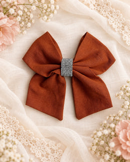 Burnt orange girls hair bow with sparkling rhinestone center