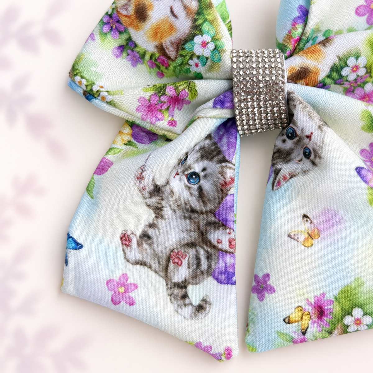 Close-up of the cotton kitten and floral print on the Whiskers in Bloom bow