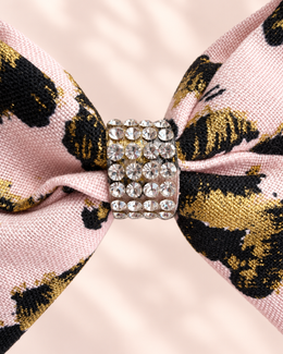 Close up of the rhinestone center and blush pink black gold fabric on Gilded Leopard mini hair bow