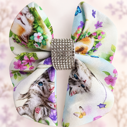 Close-up of the sparkling silver rhinestone center on a kitten cotton hair bow