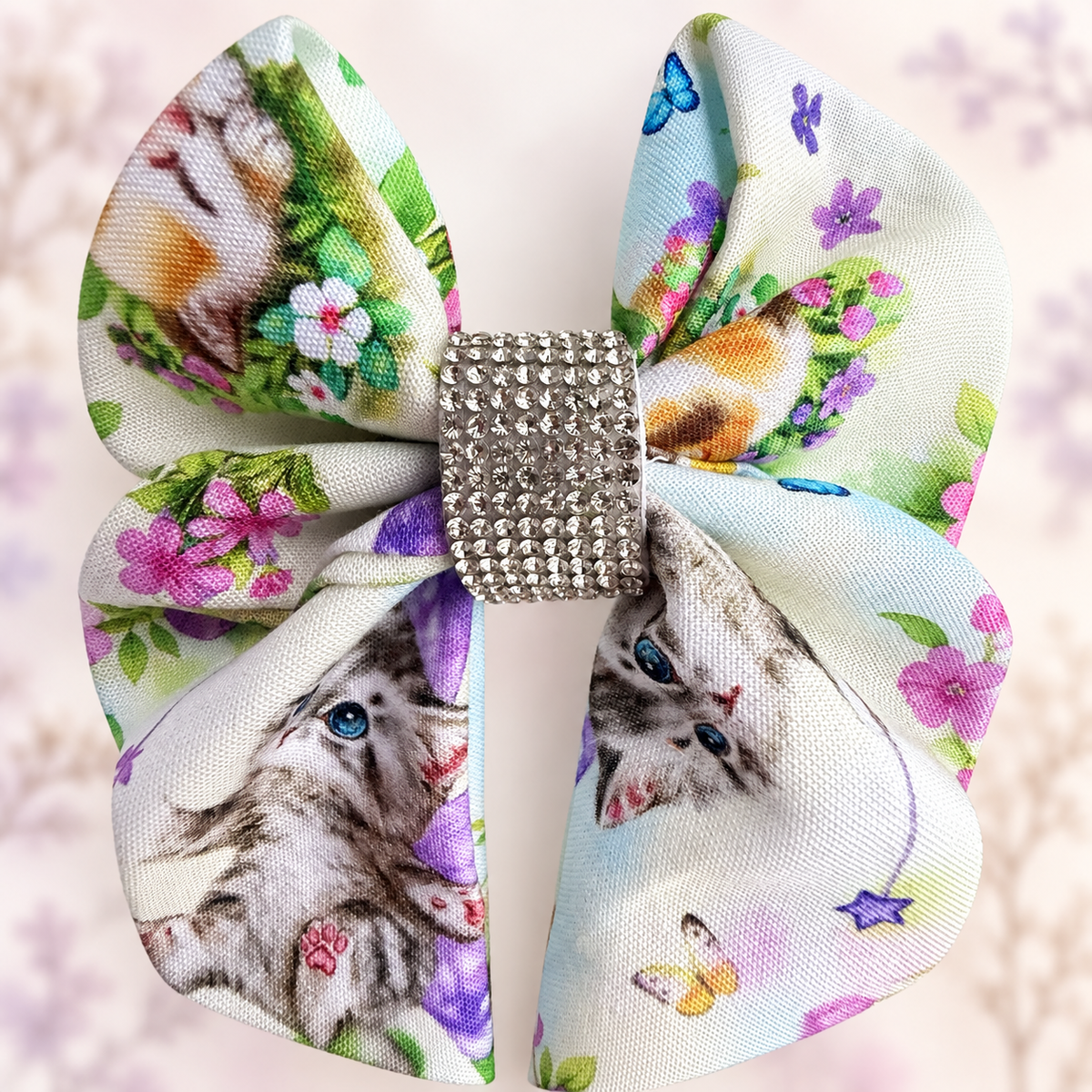 Close-up of the sparkling silver rhinestone center on a kitten cotton hair bow