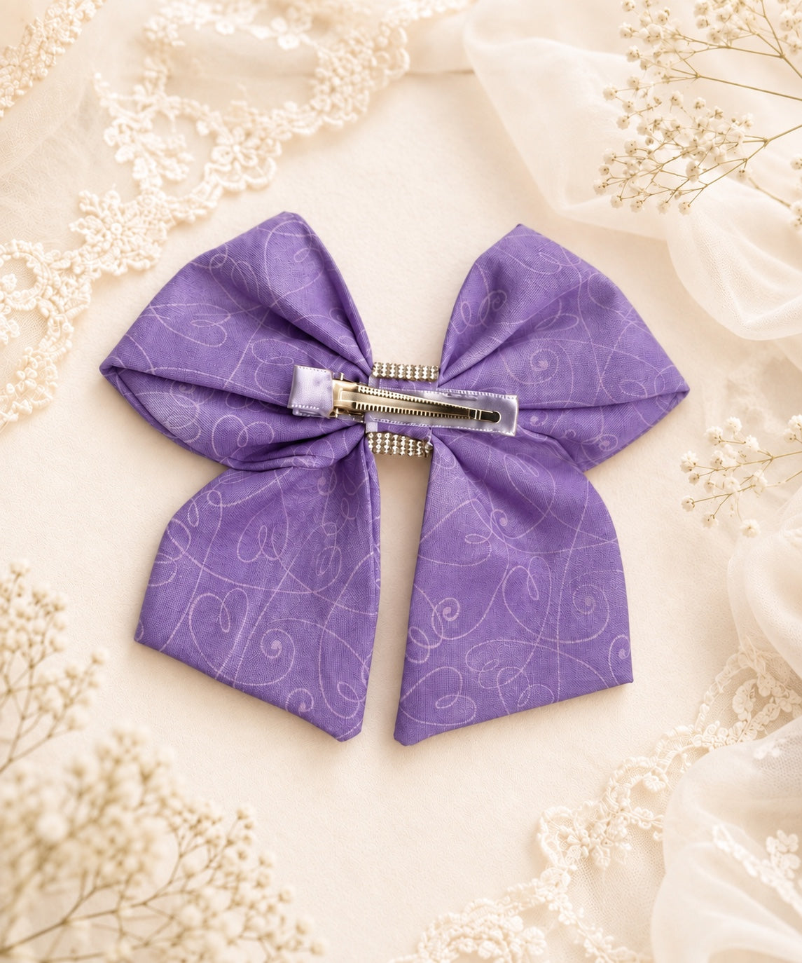 Back view of lavender purple rhinestone hair bow showing attached alligator clip