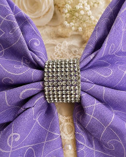 Detailed view of sparkling rhinestone center on lavender swirl print hair bow