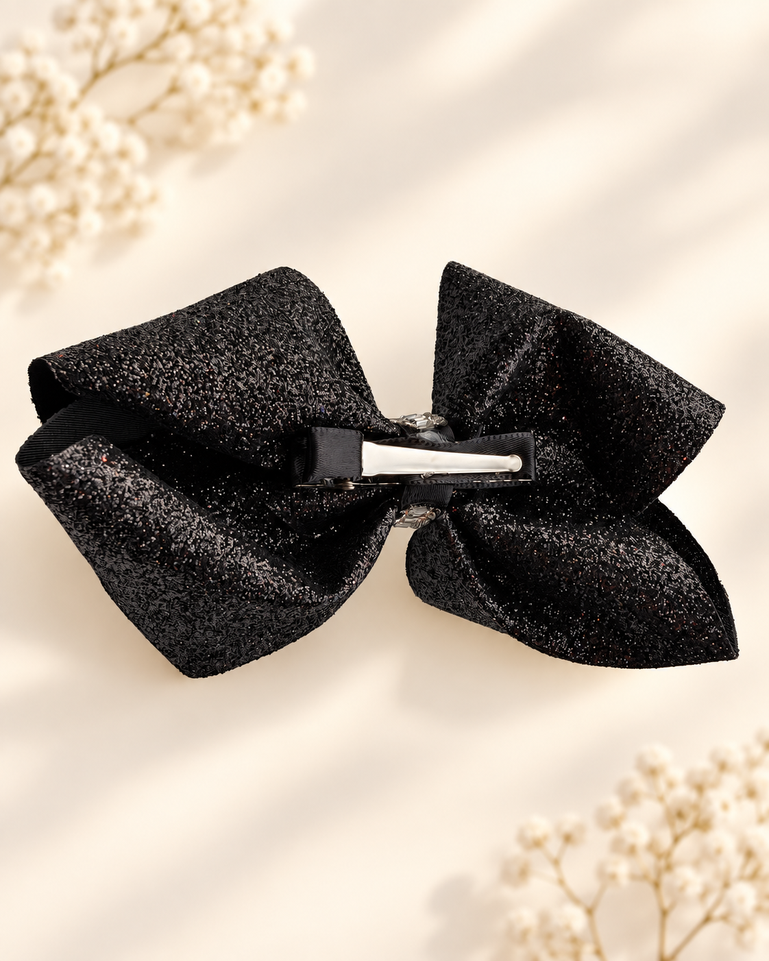 Back view of 5.5 inch black glitter hair bow with silver alligator clip