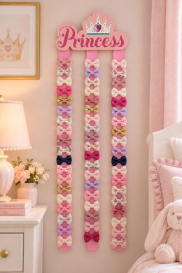 Princess hair bow organizer with bows on ribbons in nursery